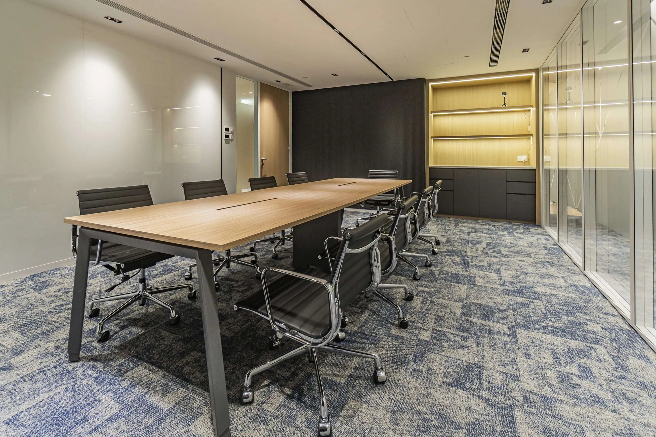 Hong Kong office boardroom with a timber meeting table and glass partitions