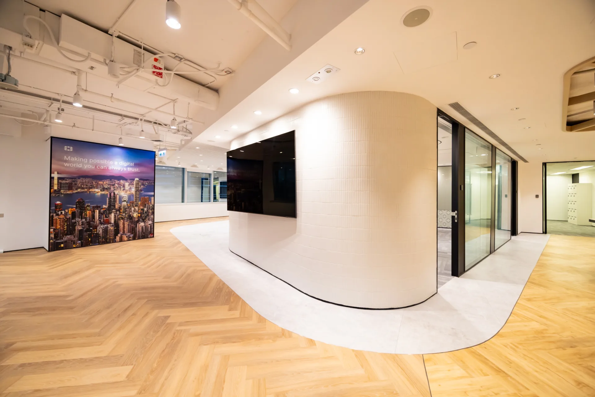 Hong Kong office design with a curved tiled wall and herringbone flooring
