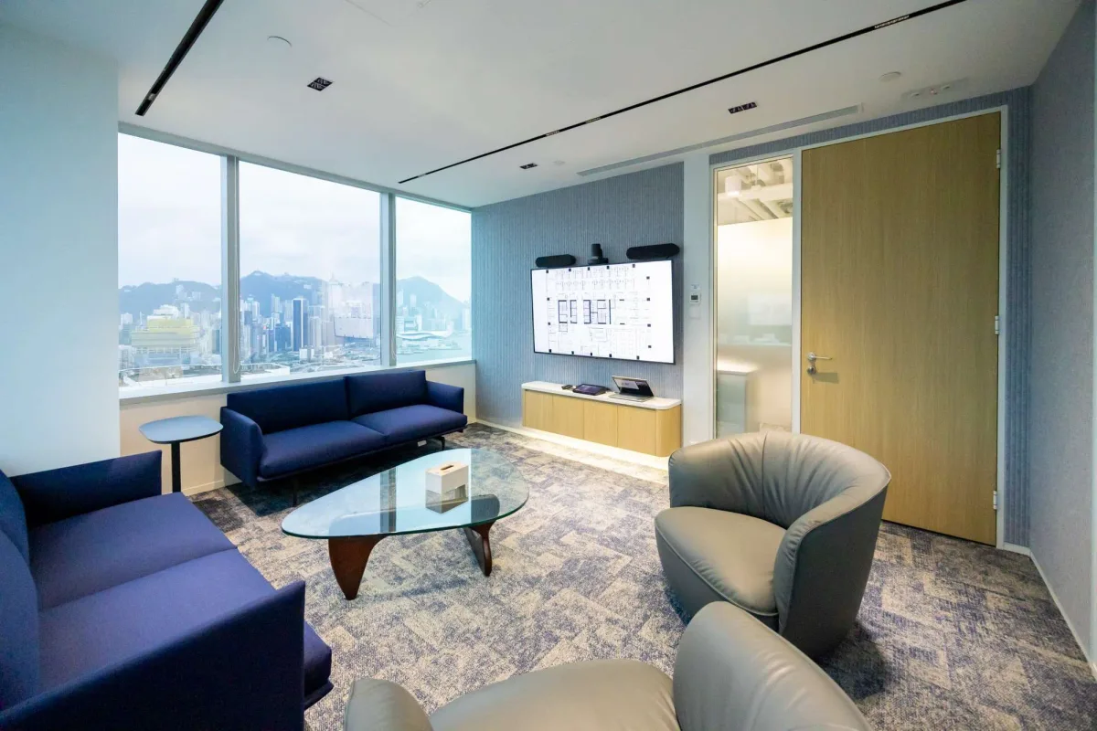 Hong Kong office lounge with city views, soft seating and meeting technology
