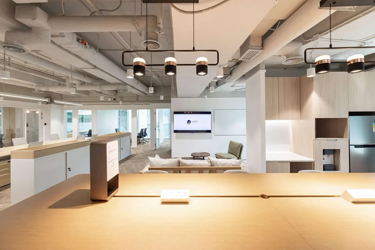 Hong Kong open office interior with reception, collaboration space and warm lighting