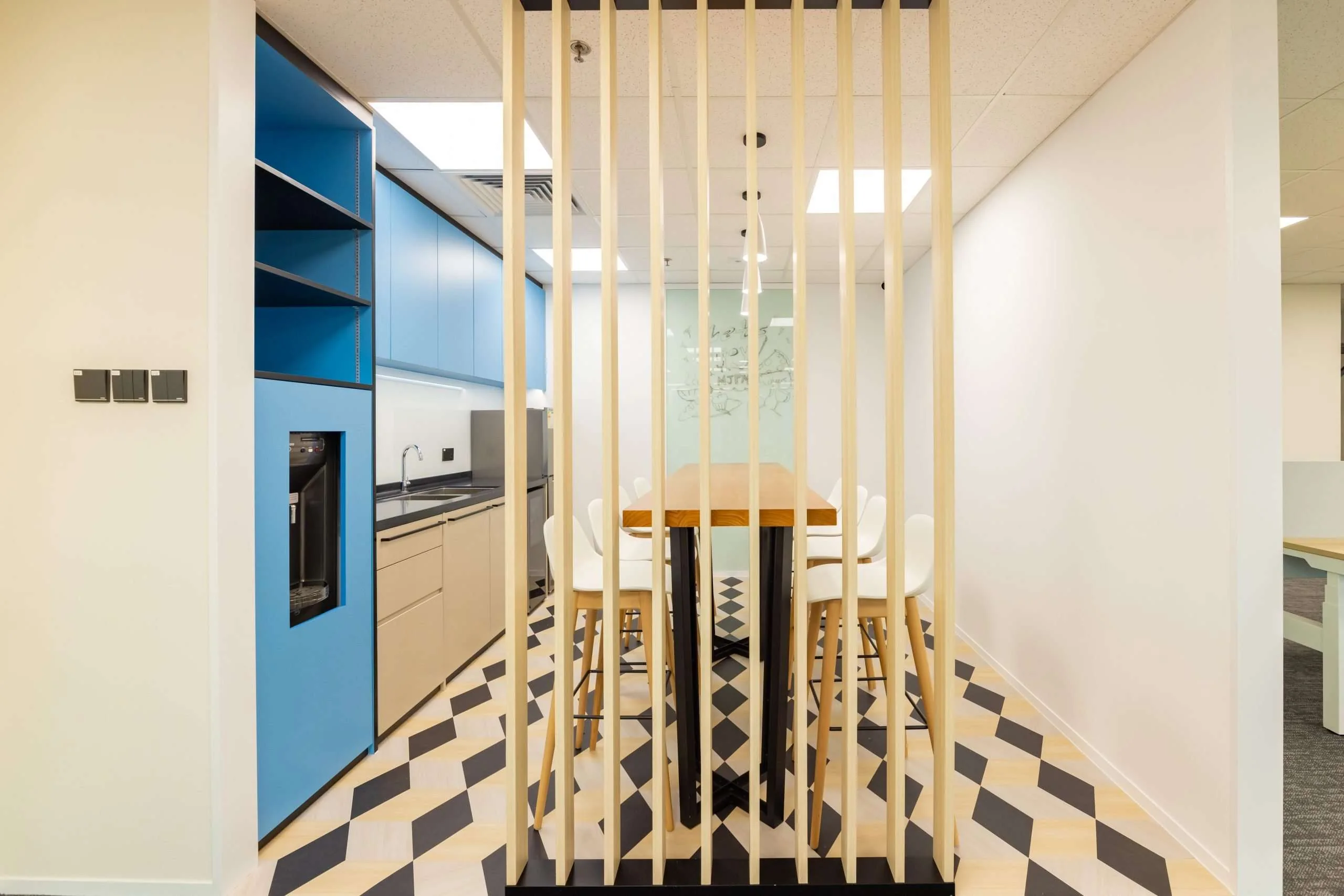 MJPM case study showing a finished workplace pantry with timber detailing and social space