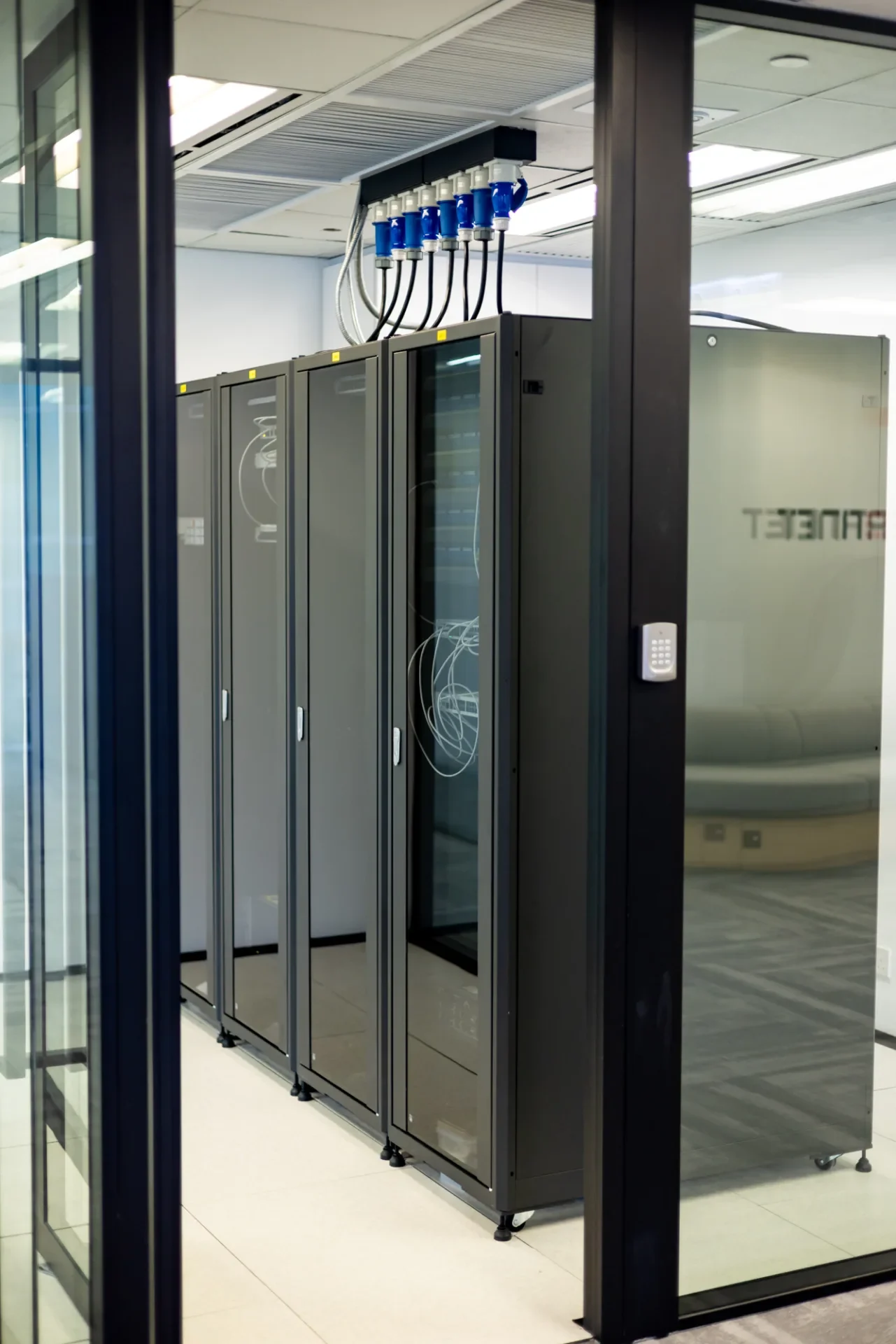 Secure Fortinet server room with network cabinets and overhead structured cabling